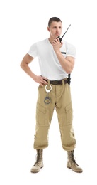 Male security guard using portable radio transmitter on white background