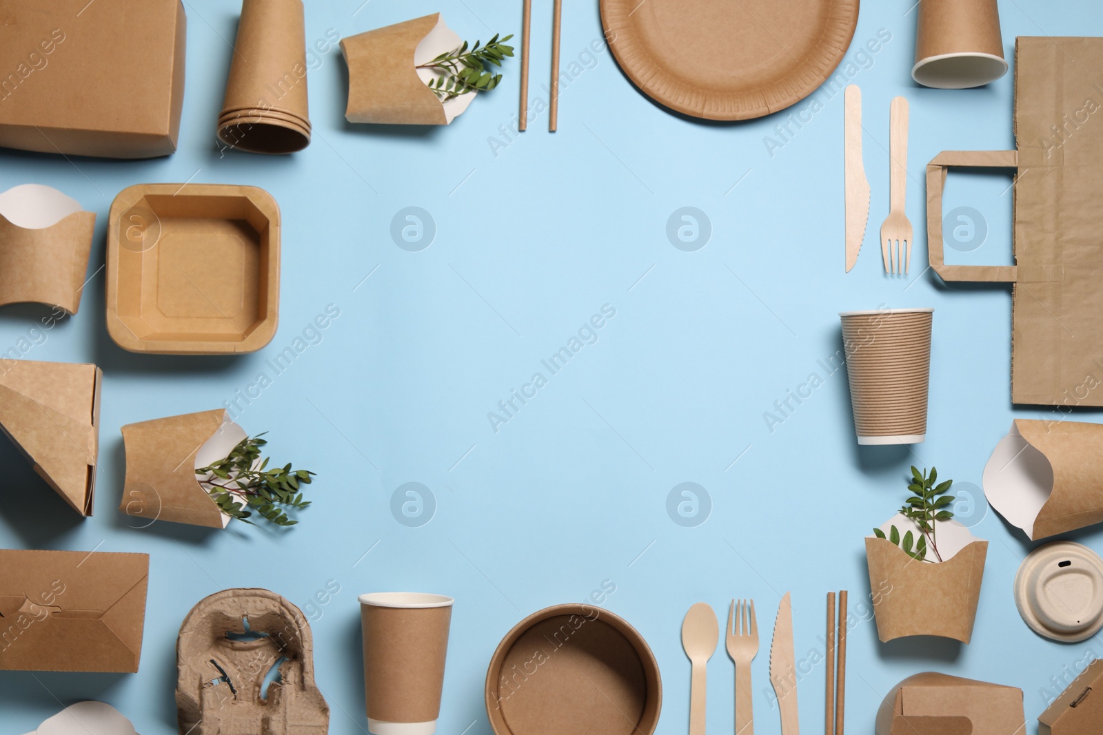 Photo of Frame of eco friendly food packagings and twigs on light blue background, flat lay. Space for text