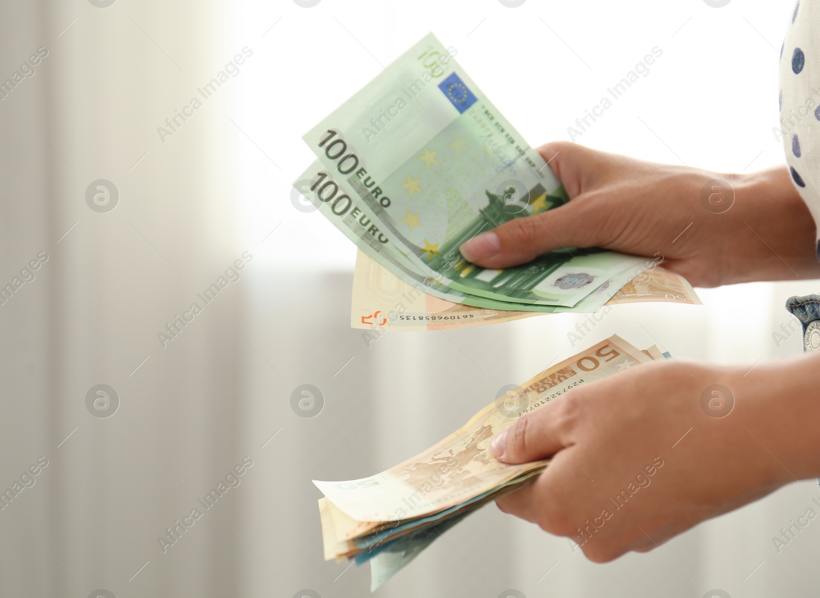 Photo of Woman with Euro banknotes in room, closeup. Space for text