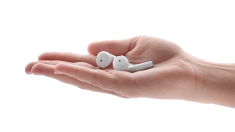 Photo of Woman holding modern wireless earphones on white background, closeup