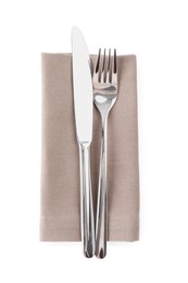 Photo of Napkin with silver fork and knife isolated on white, top view. Cutlery set