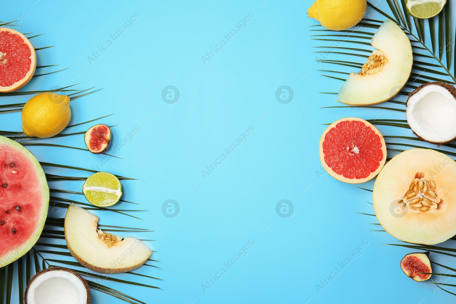 Photo of Flat lay composition with melon, other fruits and space for text on color background