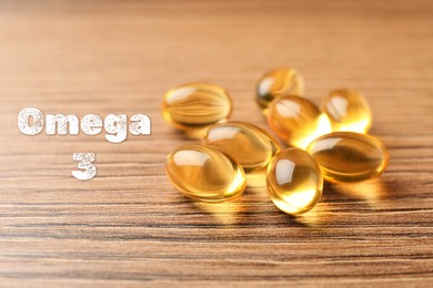 Omega 3. Fish oil capsules on wooden table, closeup