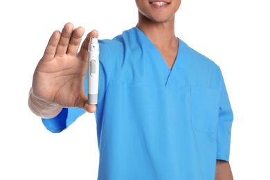 Male doctor holding lancet pen on white background, closeup. Medical object