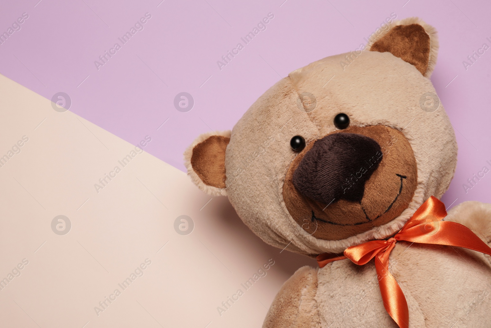 Photo of Cute teddy bear on color background, top view. Space for text