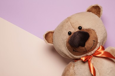 Cute teddy bear on color background, top view. Space for text