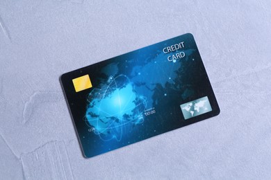 One credit card on grey textured table, top view