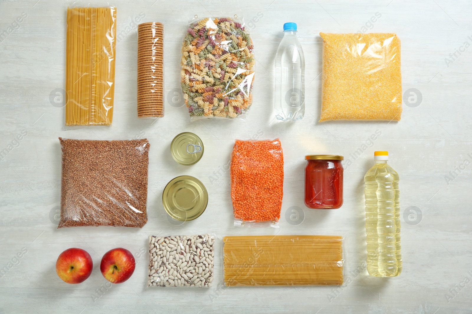 Photo of Many different products on white wooden background, flat lay. Food donation