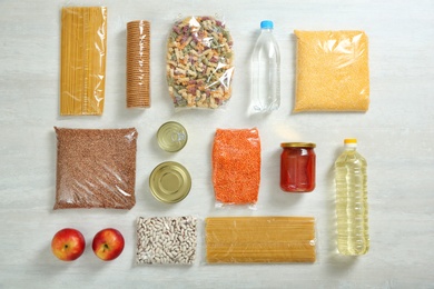 Photo of Many different products on white wooden background, flat lay. Food donation