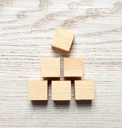 Photo of Blank cubes on white wooden table, flat lay with space for text. Idea concept