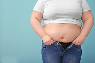 Overweight woman on color background