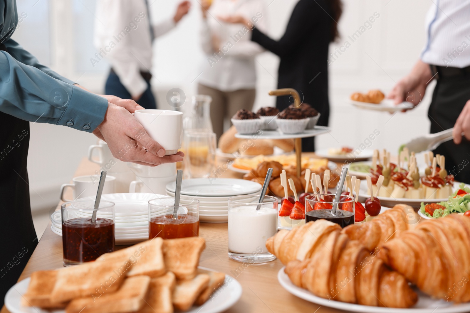 Photo of Coworkers having business lunch in restaurant, closeup