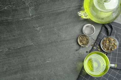 Photo of Flat lay composition with cup of green tea on grey table. Space for text