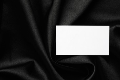 Blank business card on black fabric, top view. Mockup for design