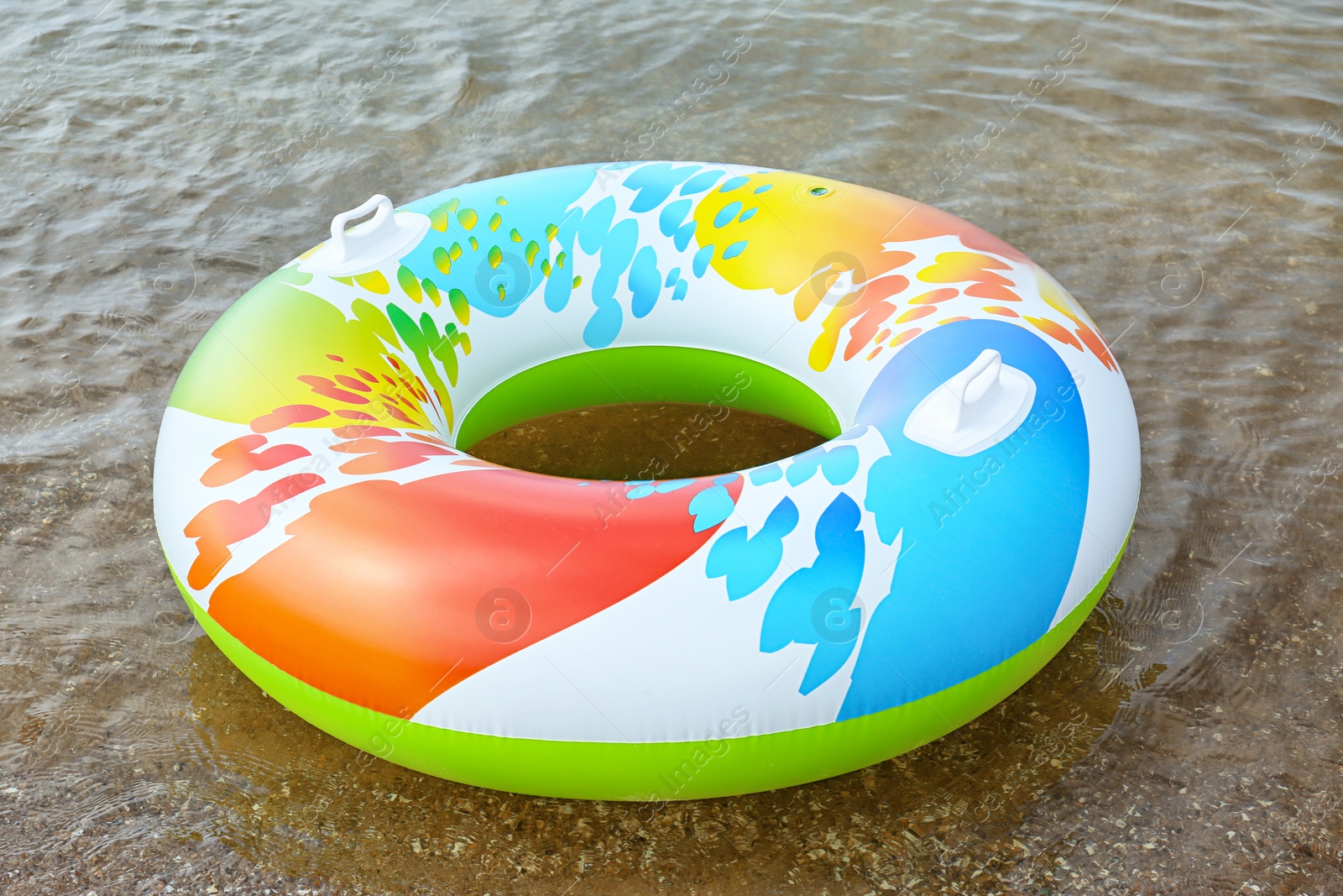 Photo of Bright inflatable ring floating on sea water. Summer vacation