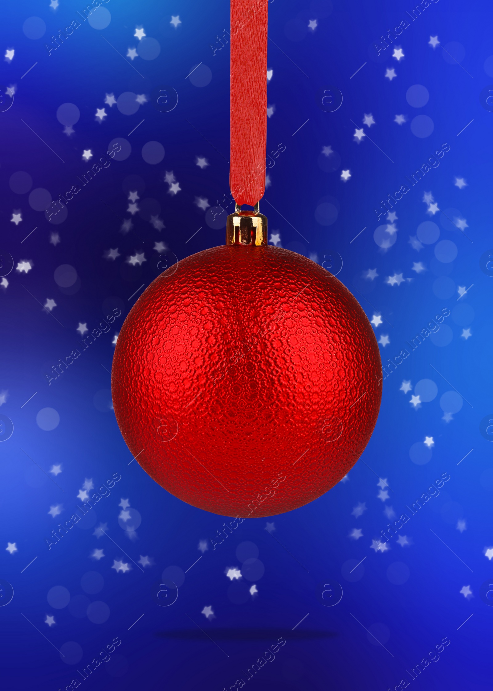 Image of Beautiful red Christmas ball hanging on blue background