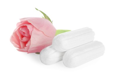 Photo of Tampons and beautiful rose on white background