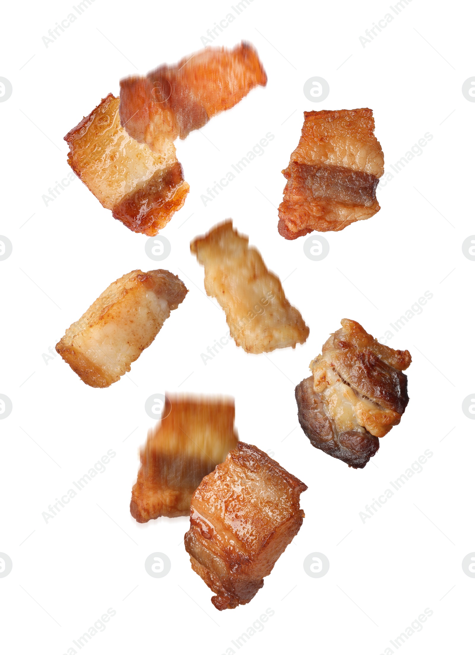 Image of Tasty fried cracklings falling on white background. Cooked pork lard