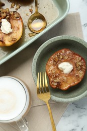 Photo of Tasty baked quinces with nuts and cream cheese served on white marble table, flat lay