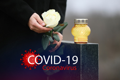 Funeral ceremony devoted to coronavirus victims. Woman holding rose near tombstone with candle outdoors, closeup