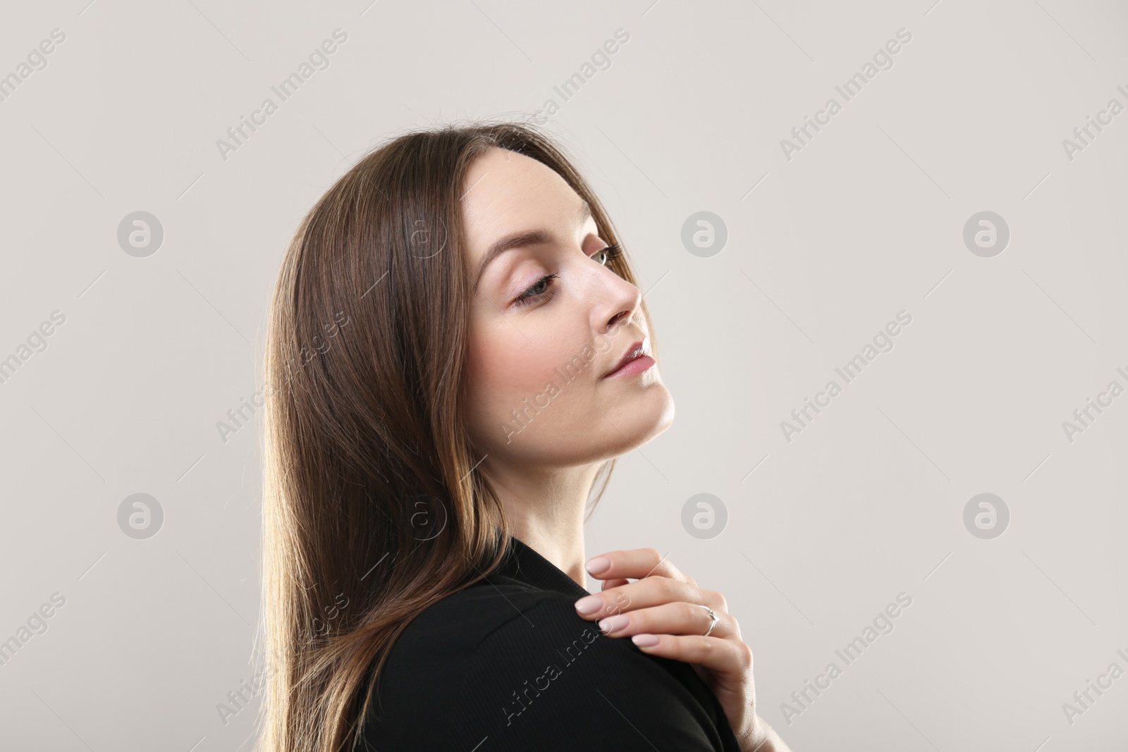 Photo of Portrait of beautiful young woman on beige background