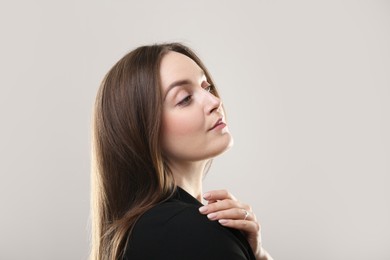 Photo of Portrait of beautiful young woman on beige background