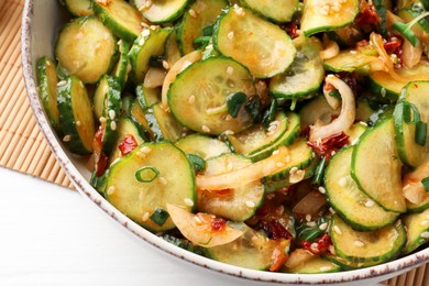 Bowl of delicious cucumber salad on table, closeup