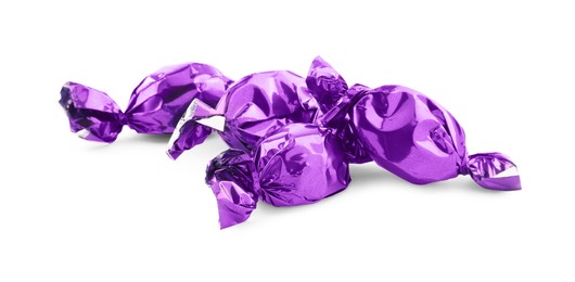 Photo of Candies in purple wrappers isolated on white