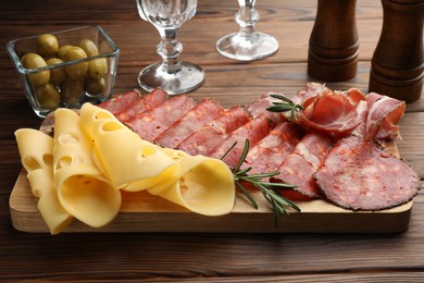 Photo of Delicious charcuterie board served on wooden table