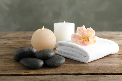 Photo of Composition with spa stones on wooden table