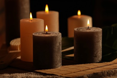 Photo of Spa composition with burning candles on massage table in wellness canter, closeup
