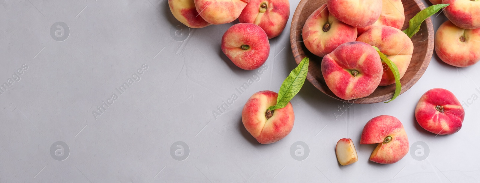 Image of Fresh flat peaches on light table, top view. Banner design with space for text