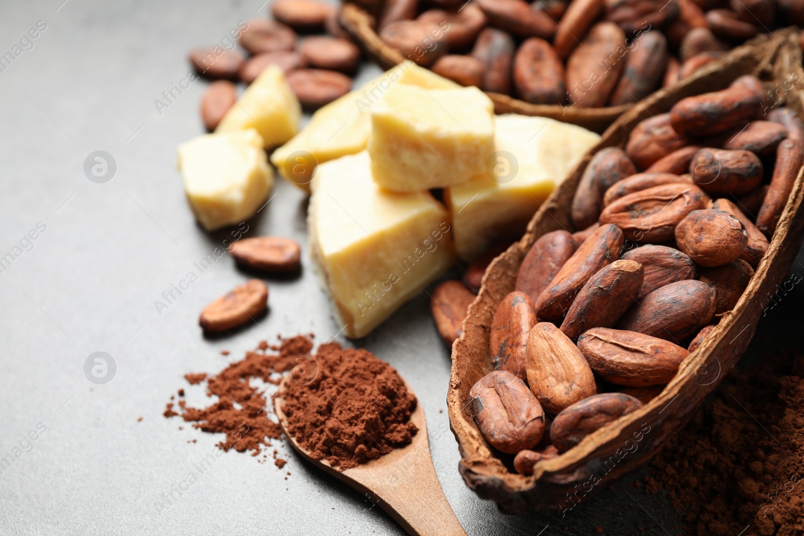 Photo of Composition with organic cocoa butter on grey table, closeup