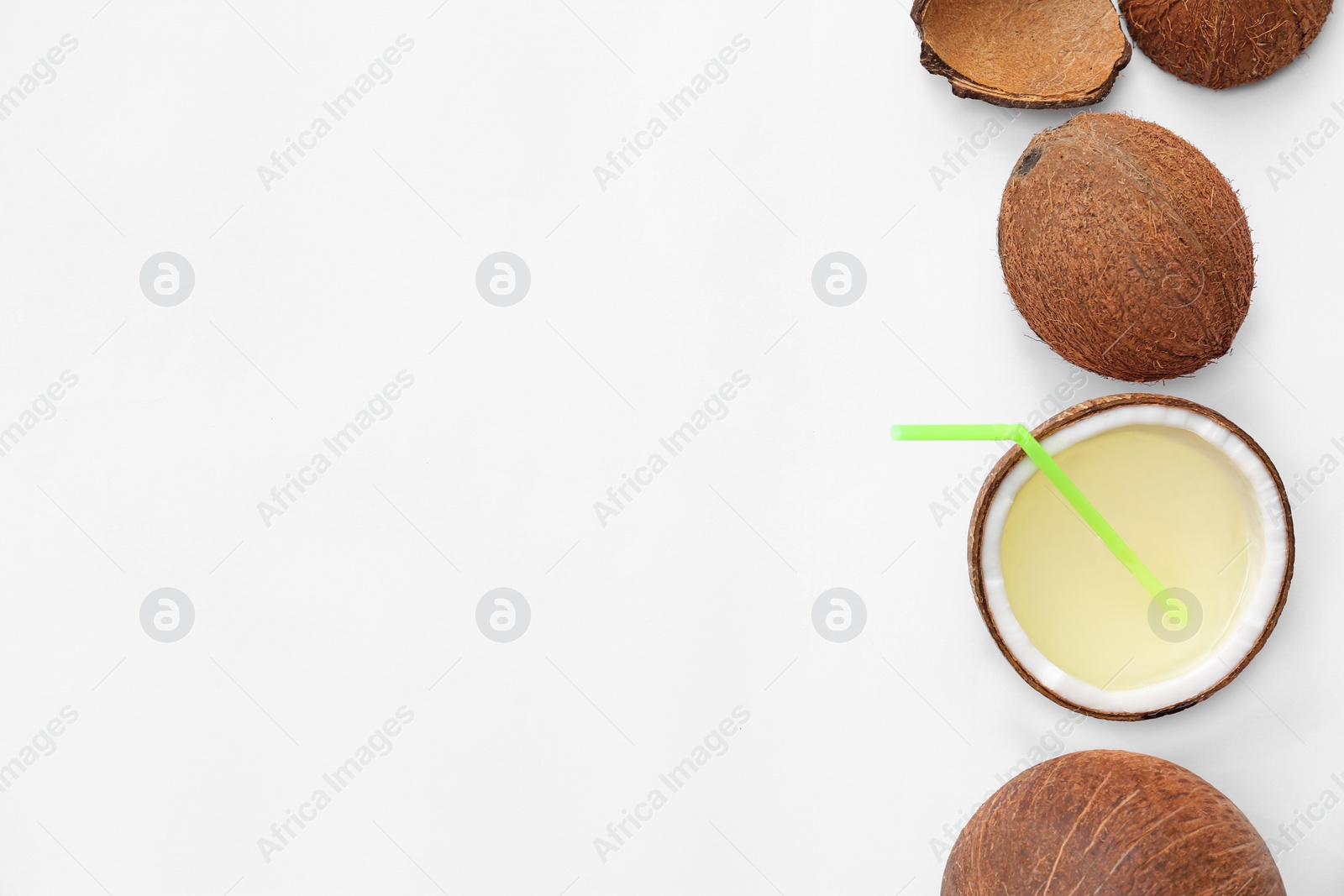 Photo of Composition with drink in half of coconut on white background, top view