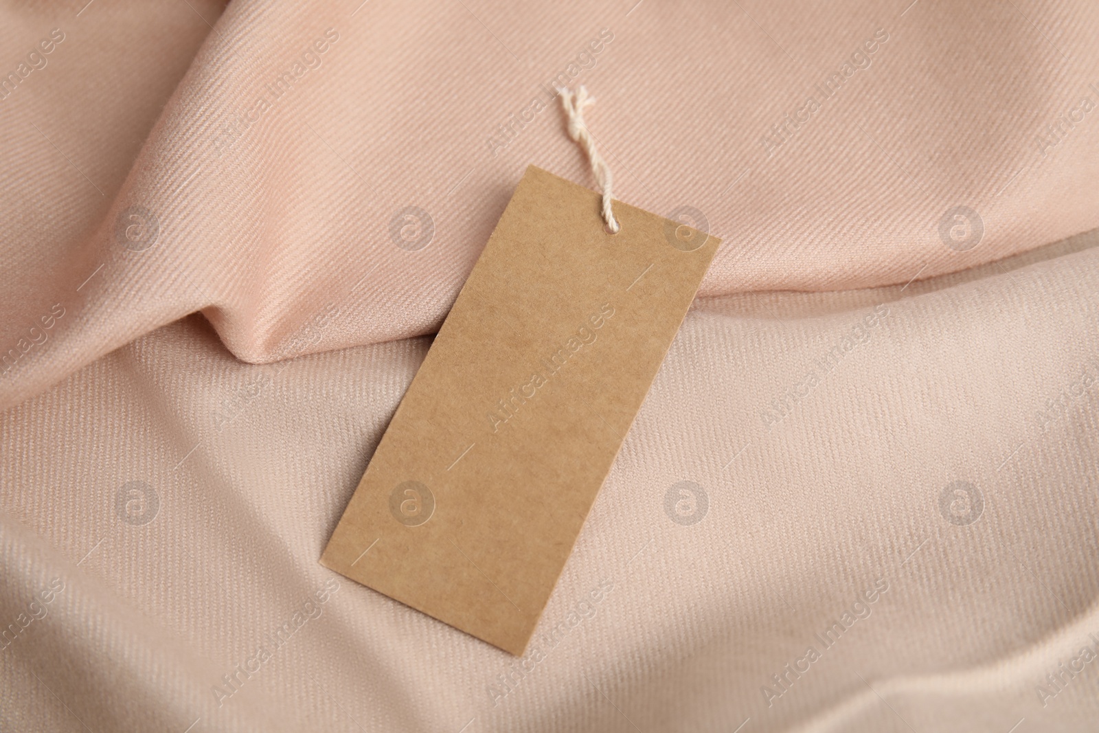 Photo of Warm beige cashmere garment with tag, closeup