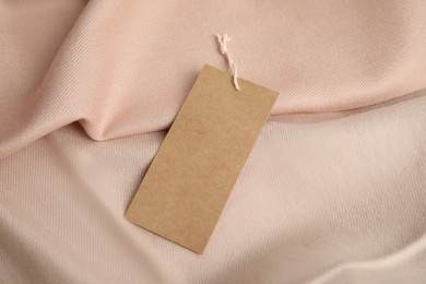 Photo of Warm beige cashmere garment with tag, closeup