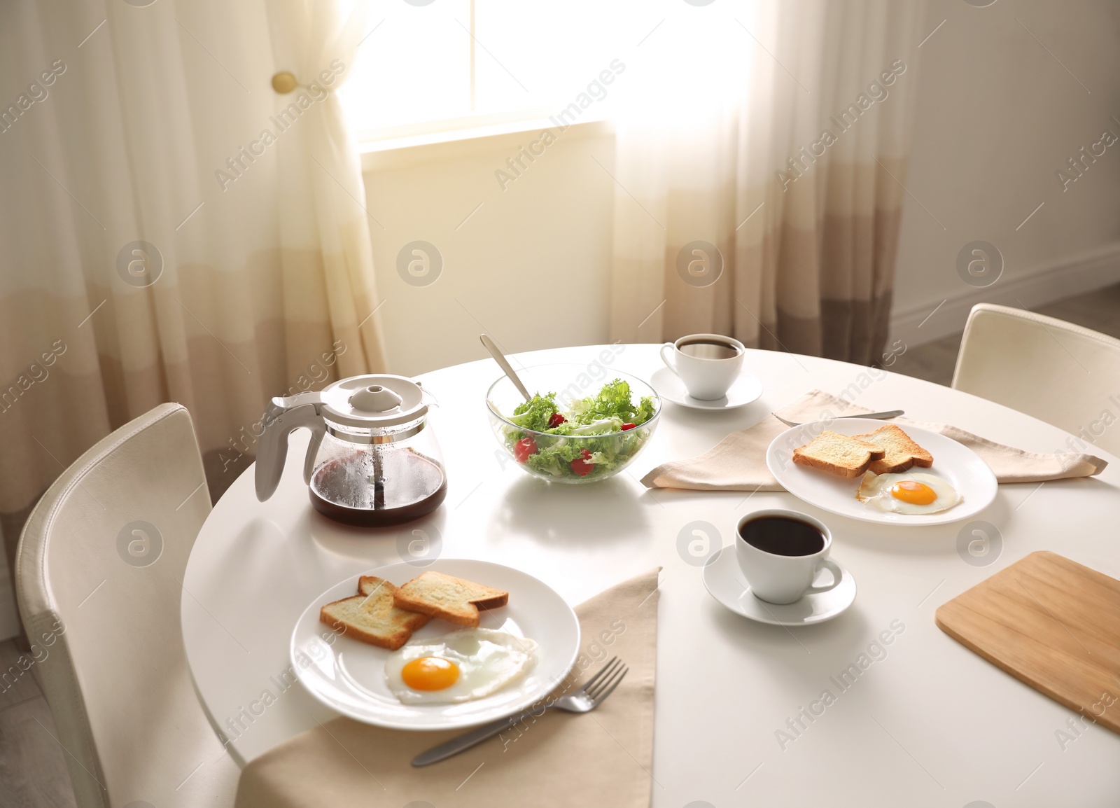 Photo of Tasty breakfast served on table in light room
