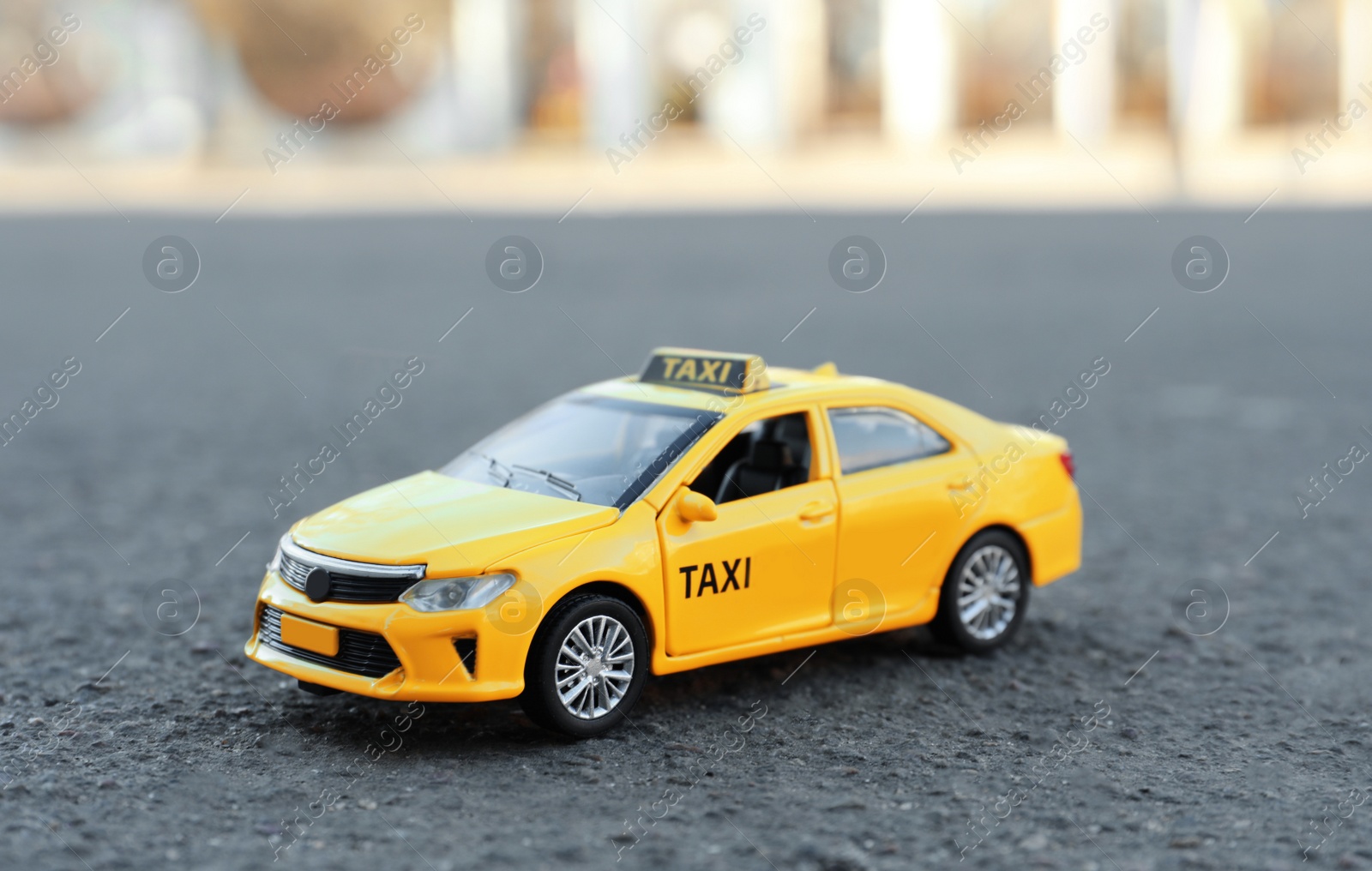 Photo of Yellow taxi car model on city street