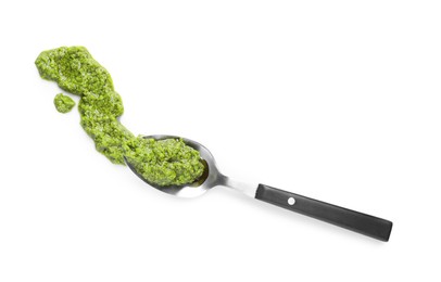 Photo of Sample of tasty pesto sauce and spoon isolated on white, top view