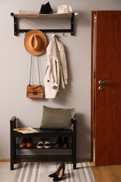 Hallway interior with stylish furniture, clothes and accessories