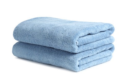 Folded clean soft towels on white background