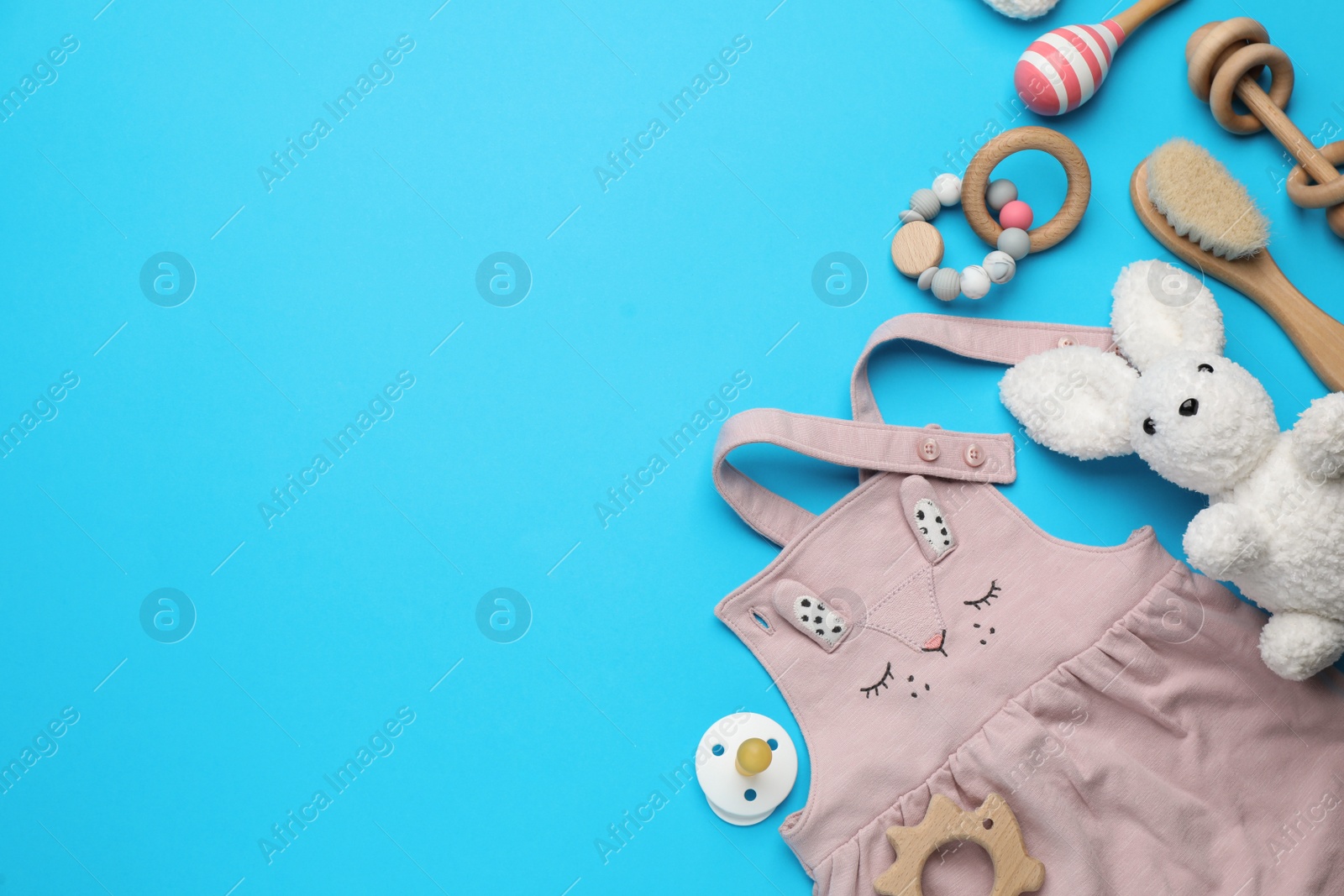 Photo of Flat lay composition with cute baby stuff on light blue background, space for text