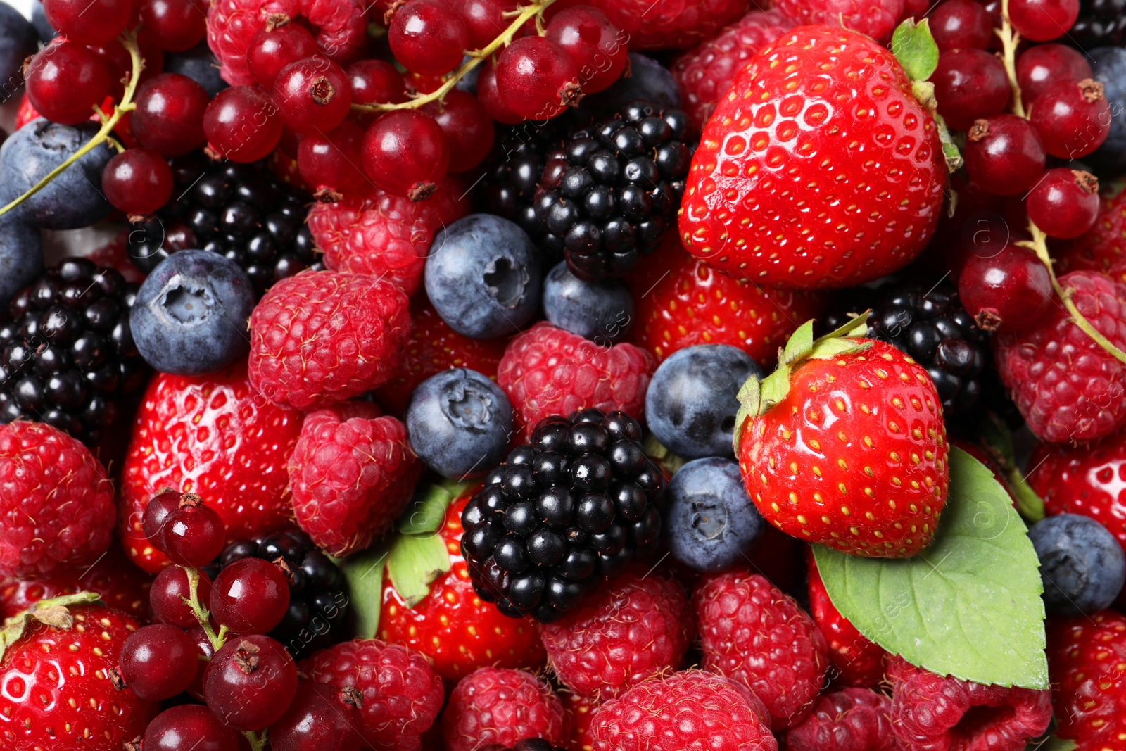 Photo of Different fresh ripe berries as background, top view