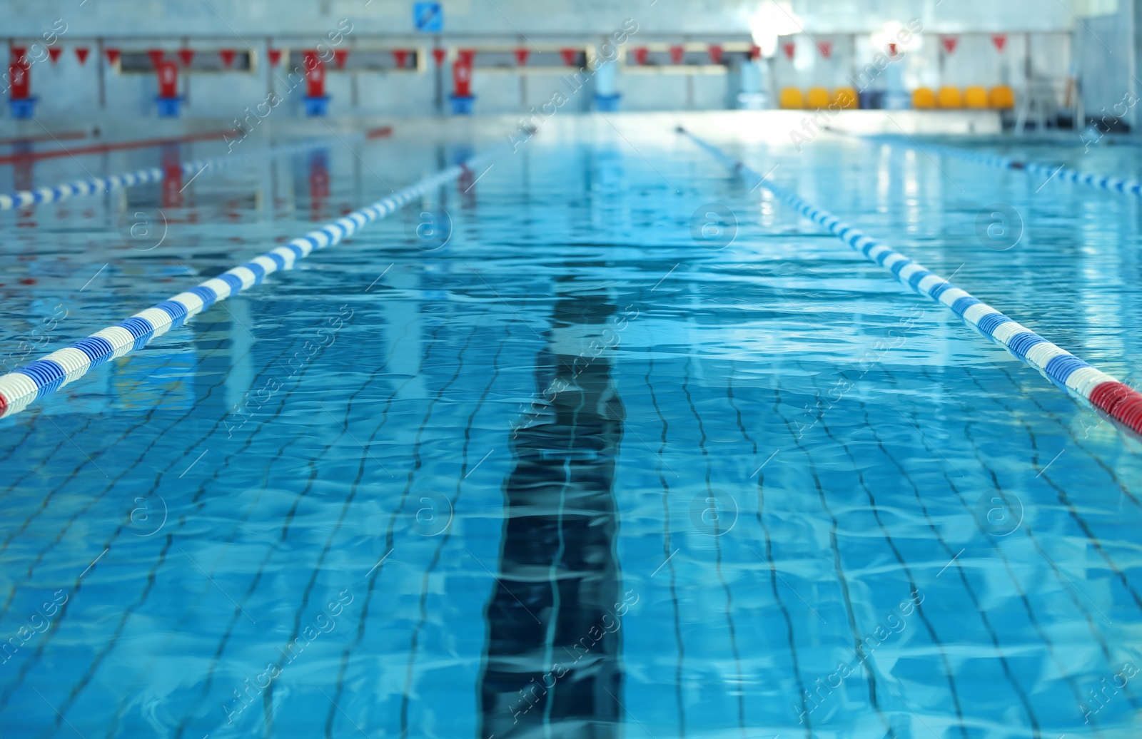 Photo of Modern swimming pool with blue water, indoors