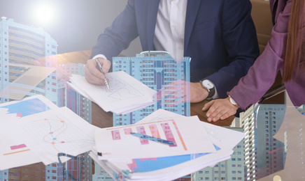 Double exposure of business people working with documents and cityscape, closeup