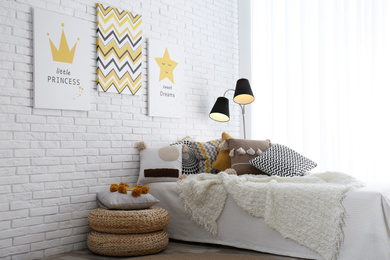 Photo of Child's room interior with bed and cute posters on wall