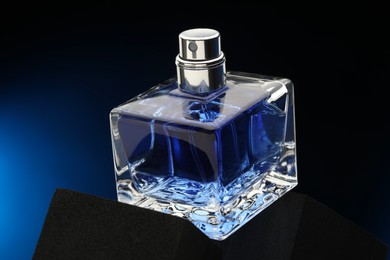 Photo of Luxury men`s perfume in bottle against dark background