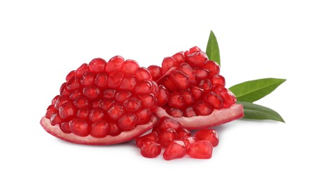 Photo of Pieces of ripe juicy pomegranate and green leaves on white background