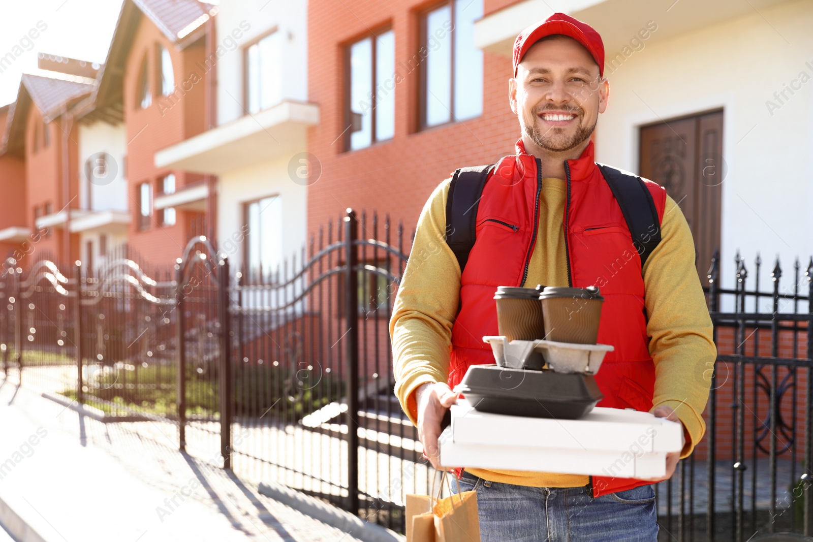 Photo of Male courier delivering food in city on sunny day