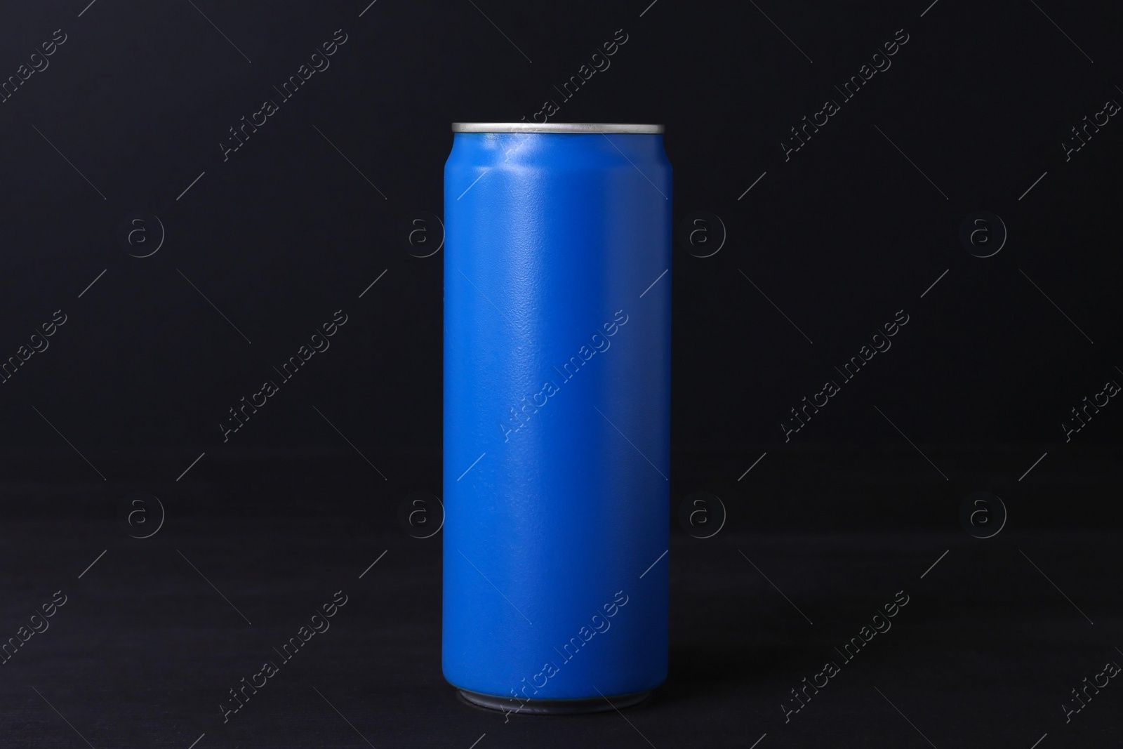 Photo of Energy drink in blue can on black wooden table